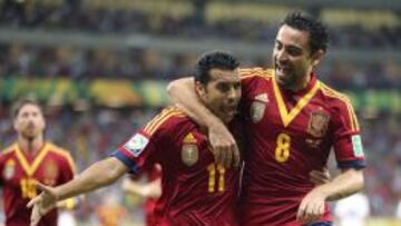 Pedro celebra el primer gol de la Selección junto a Xavi.