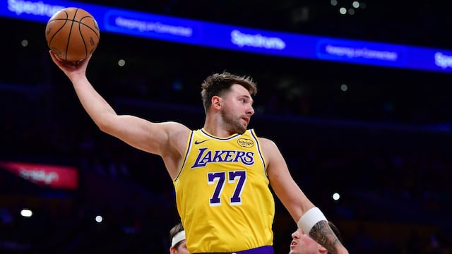 Dec 1, 2025; Los Angeles, California, USA; Los Angeles Lakers guard Luka Doncic (77) gets the rebound against the against the Phoenix Suns during the first half at Crypto.com Arena. Mandatory Credit: Gary A. Vasquez-Imagn Images