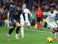 Rayo Vallecano's Romanian defender #02 Andrei Ratiu and Real Madrid's Brazilian forward #07 Vinicius Junior vie for the ball during the Spanish league football match between Real Madrid CF and Rayo Vallecano de Madrid at the Santiago Bernabeu stadium in Madrid on March 9, 2025. (Photo by Thomas COEX / AFP)