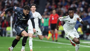 Rayo Vallecano's Romanian defender #02 Andrei Ratiu and Real Madrid's Brazilian forward #07 Vinicius Junior vie for the ball during the Spanish league football match between Real Madrid CF and Rayo Vallecano de Madrid at the Santiago Bernabeu stadium in Madrid on March 9, 2025. (Photo by Thomas COEX / AFP)
