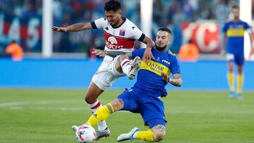 Soccer Football - Argentina Primera Division - Final - Boca Juniors v Tigre - Estadio Mario Alberto Kempes, Cordoba, Argentina - May 22, 2022 Tigre's Brian Luciatti in action with Boca Juniors' Dario Benedetto REUTERS/Agustin Marcarian