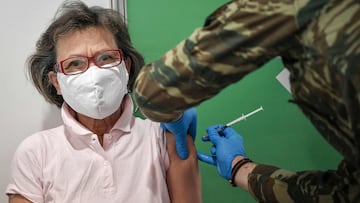 A woman receives a dose of Moderna Covid-19 vaccine in a new massive vaccination center located in former Hellinikon Olympic center in Athens on April 2, 2021. - Greece plans to reopen most shops and relax leisure restrictions despite persistently high Co