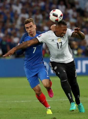 Antoine Griezmann tussles with Jerome Boateng.
