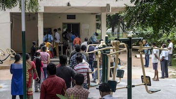 Residents line up to register their names before giving swab samples to test for the Covid-19 coronavirus at a community gym centre on the outskirts of Hyderabad on October 8, 2020. (Photo by NOAH SEELAM / AFP)