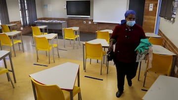 FILE PHOTO: A worker walks past safely spaced desks following safe distancing measures amid the spread of the coronavirus disease (COVID-19) outbreak, at the Seshegong secondary school in Olivenhoutbosch, South Africa, May 28, 2020. REUTERS/Siphiwe Sibeko