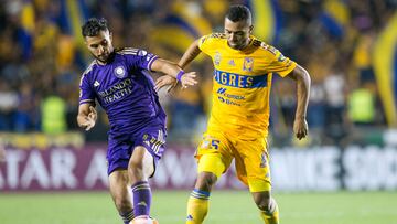 Mexico's Tigres Brazilian midfielder Rafael De Souza (R) fights for the ball with USA's Orlando City Argentine midfielder Martin Ojeda (L) during their CONCACAF Champions League football match between Tigres and Orlando City at Universitario stadium in Monterrey, Mexico, on March 7, 2023. (Photo by Julio Cesar AGUILAR / AFP)