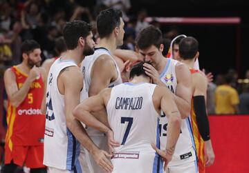 Facundo Campazzo comforted by his teammates after final.