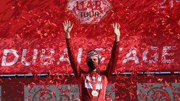 Race leader Tadej Pogacar of Team UAE Emirates celebrates on the podium after the sixth stage of the UAE Cycling Tour From Dubai Deira Islands to Dubai - Palm Jumeriah on February 26, 2021. (Photo by Giuseppe CACACE / AFP)