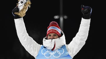 Gold medallist Norway's Joergen Graabak celebrates on the podium after winning the cross-country race of the Nordic Combined men's individual large hill/10km event during the Beijing 2022 Winter Olympic Games at the Zhangjiakou National Cross-Co