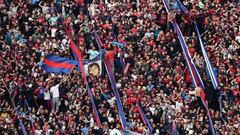 Fans of San Lorenzo cheer for their team during their Argentine Professional Football League Tournament 2022 match against Boca Juniors at Nuevo Gasometro stadium in Buenos Aires, on July 9, 2022. (Photo by ALEJANDRO PAGNI / AFP) (Photo by ALEJANDRO PAGNI/AFP via Getty Images)