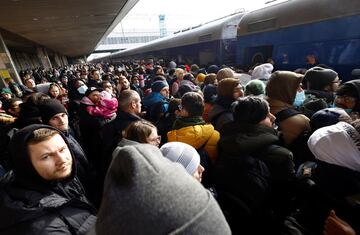 Crowds wait to board a train evacuating people from Kyiv to Lviv, at the central train station in the Ukrainian capital.