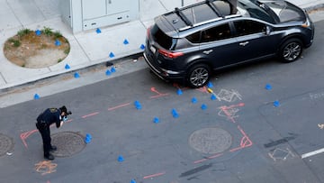 A police evidence technician photographs the crime scene after an early-morning shooting in a stretch of downtown near the Golden 1 Center arena in Sacramento, California, U.S. April 3, 2022. REUTERS/Fred Greaves