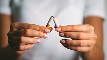 Woman brakes cigarette in hands. Woman refusing tobacco. Stop smoking, quit smoking or no smoking cigarettes. High quality photo TABACO CAJETILLA DE TABACO