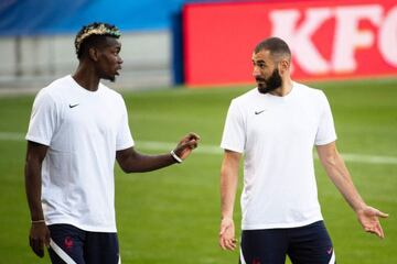 Francex92s midfielder Paul Pogba (L) speaks with Francex92s forward Karim Benzema (R) as they take part in a training session at the Meineau Stadium in Strasbourg, eastern France, on September 2, 2021, ahead of their FIFA World Cup Qatar 2022 qualificatio