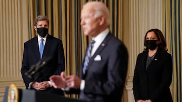 FILE PHOTO: U.S. President Joe Biden delivers remarks on tackling climate change as White House climate envoy John Kerry and Vice President Kamala Harris listen in the State Dining Room at the White House in Washington, U.S., January 27, 2021. REUTERS/Kev