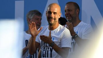 Manchester City's Spanish manager Pep Guardiola attend an event for fans with members of the Manchester City football team following an open-top bus parade through Manchester, northern England on May 14, 2018 to celebrate winning the 2018 Premier Lea