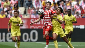 Girona's Spanish midfielder Rodrigo Riquelme (L) vies with Villarreal's Spanish defender Ramon Terrats during the Spanish league football match between Girona FC and Villarreal CF at the Montilivi stadium in Girona on May 20, 2023. (Photo by Josep LAGO / AFP)