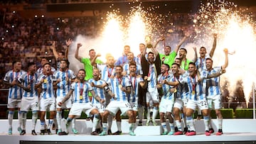 FILE PHOTO: Soccer Football - FIFA World Cup Qatar 2022 - Final - Argentina v France - Lusail Stadium, Lusail, Qatar - December 18, 2022 Argentina's Lionel Messi celebrates with the trophy and teammates after winning the World Cup REUTERS/Carl Recine/File Photo