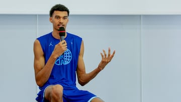 French basketball player Victor Wembanyama talks to the audience during a 5x5 France Olympics Basket Team Media Day in Paris, on June 27, 2024. France must avoid extremes in upcoming legislative elections, French basketball star Victor Wembanyama said on June 27, 2024, three days ahead of the first round of voting expected to be won by the far right. (Photo by Geoffroy VAN DER HASSELT / AFP)