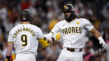 Jun 20, 2024; San Diego, California, USA; San Diego Padres right fielder Fernando Tatis Jr. (right) celebrates with second baseman Jake Cronenworth (9) after hitting a home run against the Milwaukee Brewers during the fifth inning at Petco Park. Mandatory Credit: Orlando Ramirez-USA TODAY Sports
