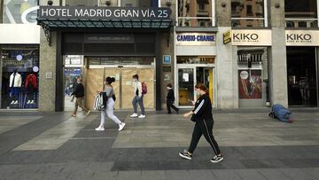 MADRID, SPAIN - SEPTEMBER 29: Some people walk through the door of the closed Madrid Gran Via 25 Hotel on September 29, 2020 in Madrid, Spain. The iconic street of Gran Via, the busiest in Spain and the third in Europe, hosts a lot of theatres, cinemas, souvenir stores and restaurants. Many of them are still closed, more than six months after the coronavirus outbreak hit Madrid. (Photo by Carlos Alvarez/Getty Images)