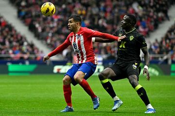 Atletico Madrid's Argentinian forward #10 Angel Correa (L) fights for the ball with Almeria's Senegalese midfielder #06 Dion Lopy during the Spanish league football match between Club Atletico de Madrid and UD Almeria at the Metropolitano stadium in Madrid on December 10, 2023. (Photo by JAVIER SORIANO / AFP)