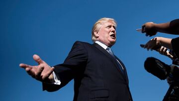 (FILES) This file photo taken on September 24, 2017 shows US President Donald Trump speaking to the press while boarding Air Force One at Morristown Airport in Morristown, New Jersey.
US President Donald Trump denied stoking racial tensions on September 25, 2017, insisting his charged comments that prompted a wave of symbolic protests by NFL players were about patriotism. After his verbal attacks on black athletes led players across the country to kneel in solidarity during the US national anthem at games over the weekend, the besieged US president played defense on Twitter. Trump had sparked the furor by describing NFL players who chose to take a knee through renditions of "The Star-Spangled Banner" as "sons of bitches" who should be fired.
/ AFP PHOTO / Brendan Smialowski