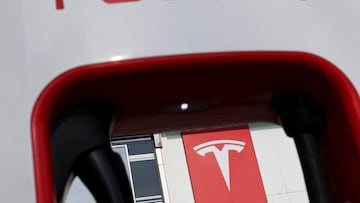 FILE PHOTO: The Tesla logo is seen through a charging station outside a store of the electric vehicle (EV) maker in Beijing, China January 4, 2024. REUTERS/Florence Lo/File Photo