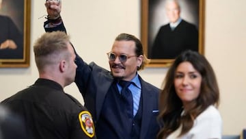 Actor Johnny Depp gestures to spectators in court after closing arguments at the Fairfax County Circuit Courthouse in Fairfax, Virginia, on May 27, 2022. - Actor Johnny Depp is suing ex-wife Amber Heard for libel after she wrote an op-ed piece in The Washington Post in 2018 referring to herself as a public figure representing domestic abuse. (Photo by Steve Helber / POOL / AFP) (Photo by STEVE HELBER/POOL/AFP via Getty Images)