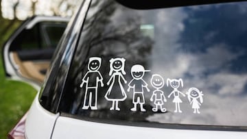 Happy family on board. Sticker on the back of car. Four kids.