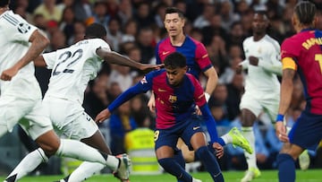 Barcelona's Spanish forward #19 Lamine Yamal (C) is challenged by Real Madrid's German defender #22 Antonio Ruediger during the Spanish league football match between Real Madrid CF and FC Barcelona at the Santiago Bernabeu stadium in Madrid on October 26, 2024. (Photo by Pierre-Philippe MARCOU / AFP)