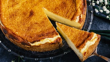 Cheesecake on a plate decorated with white flowers. Part of a series.