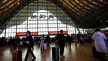 FILE PHOTO: People wait with luggages at a railway station, amid the coronavirus disease (COVID-19) outbreak, in Wuhan, Hubei province, China January 1, 2023. REUTERS/Tingshu Wang/File Photo