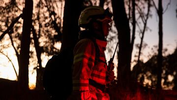 A firefighter observes the fire during emergency response to extinguish a forest fire on a hill in Bogota, Colombia January 24, 2024. REUTERS/Antonio Cascio