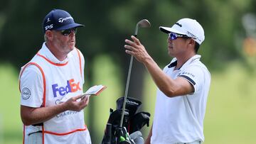 MEMPHIS, TENNESSEE - AUGUST 11: Kurt Kitayama of the United States and his caddie Tim Tucker wait to play a shot on the 10th hole during the second round of the FedEx St. Jude Championship at TPC Southwind on August 11, 2023 in Memphis, Tennessee.   Andy Lyons/Getty Images/AFP (Photo by ANDY LYONS / GETTY IMAGES NORTH AMERICA / Getty Images via AFP)