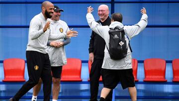 Belgium's assistant coach Thierry Henry jokes with staff members during a training session at the Guchkovo Stadium in Dedovsk, outside Moscow, on July 9, 2018, on the eve of their Russia 2018 World Cup semi-final football match against France. / AFP