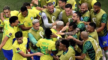 Brazil's forward #09 Richarlison (C) celebrates with teammates after scoring his team's first goal during the Qatar 2022 World Cup Group G football match between Brazil and Serbia at the Lusail Stadium in Lusail, north of Doha on November 24, 2022. (Photo by Antonin THUILLIER / AFP)