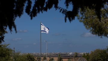 An Israeli flag flutters with the Gaza Strip in the background, nearly a year since the deadly October 7 attack by Hamas, in Kibbutz Kfar Aza, in southern Israel, September 30, 2024. REUTERS/Amir Cohen