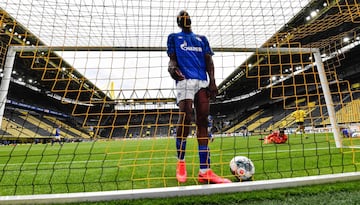 Schalke's Senegalese defender Salif Sane reacts in the goal after Dortmund's Portuguese defender Raphael Guerreiro scored his side's second goal during the German first division Bundesliga football match BVB Borussia Dortmund v Schalke 04 on May 16, 2020 