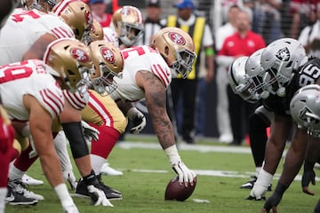 Aug 13, 2023; Paradise, Nevada, USA; A general overall view of helmets at the line of scrimmage as San Francisco 49ers guard Jon Feliciano (55) snaps the ball against the Las Vegas Raiders in the first half at Allegiant Stadium. Mandatory Credit: Kirby Lee-USA TODAY Sports