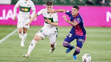 ELCHE, SPAIN - APRIL 21: Raul Guti of Elche CF (L) competes for the ball with Lucas Olaza of Real Valladolid CF (R) during the La Liga Santander match between Elche CF and Real Valladolid CF at Estadio Martinez Valero on April 21, 2021 in Elche, Spain. Sp