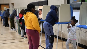 A child uses a mobile phone as people vote in the 2024 U.S. presidential election on Election Day, in Milwaukee, Wisconsin, U.S., November 5, 2024. REUTERS/Vincent Alban