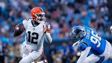 Aug 8, 2025; Charlotte, North Carolina, USA; Cleveland Browns quarterback Shedeur Sanders (12) gets away from Carolina Panthers defensive tackle Jaden Crumedy (96) during the second quarter at Bank of America Stadium. Mandatory Credit: Scott Kinser-The USAToday Network via Imagn Images