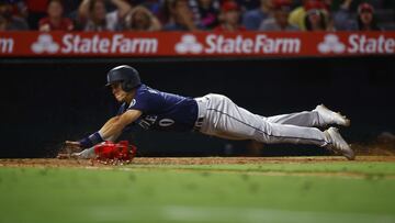 Sam Haggerty of the Seattle Mariners slides safely into home plate against the Los Angeles Angels in the ninth inning at Angel Stadium of Anaheim on August 15, 2022 in Anaheim, California.
