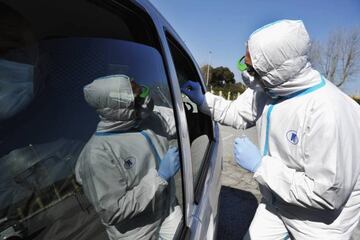 A nurse carries out swab detection for coronavirus (Covid-19) at a drive through testing facility in Livorno, Italy.