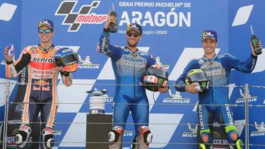 Suzuki Ecstar's Spanish rider Alex Rins celebrates (C, first), Repsol Honda Team's Spanish rider Alex Marquez (L, second) and Suzuki Ecstar's Spanish rider Joan Mir (R, third) celebrate on the podium after the MotoGP race of the Moto Grand Prix of Aragon