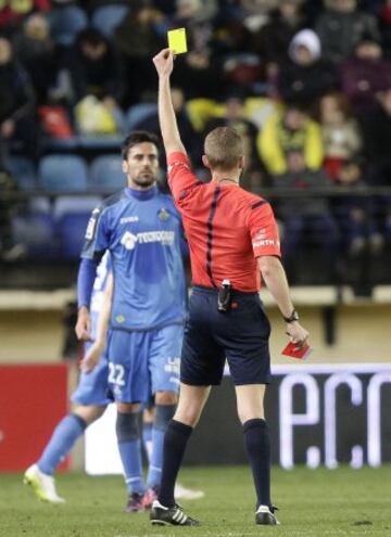 El árbitro Hernández Hernández muestra la tarjeta amarilla a Juan Rodríguez.
