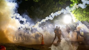 Tear gas rises above as protesters face off with police during a demonstration outside the White House over the death of George Floyd at the hands of Minneapolis Police in Washington, DC, on May 31, 2020.