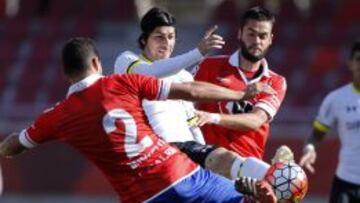 El jugador de Colo Colo, Jaime Valdes, centro, disputa el balón con la defensa de Unión La Calera.