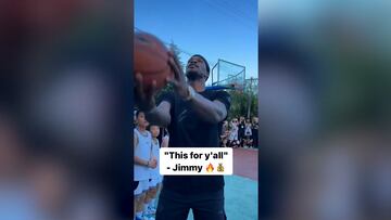 Miami Heat's star player shows off his skills on the court, shooting a basket behind his head and making it, no problem.